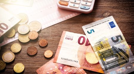 Euro,Banknotes,And,Coins,With,Bills,To,Pay.,Finances,And